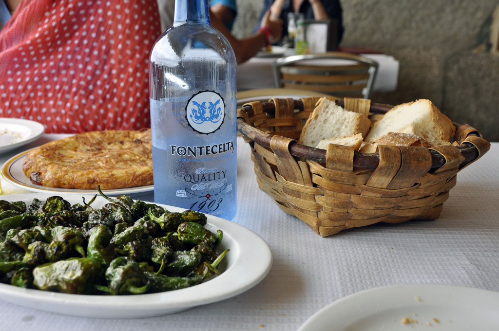 Pimientos de padron, and in the background the basis of Spanish cuisine — tortilla de patatas